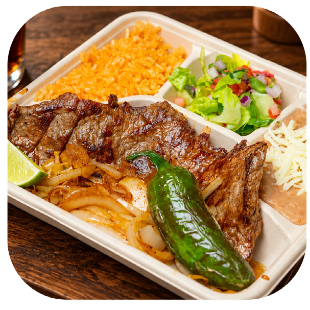 Carne asada plate with grilled steak, onions, a roasted jalapeño, rice, beans and salad